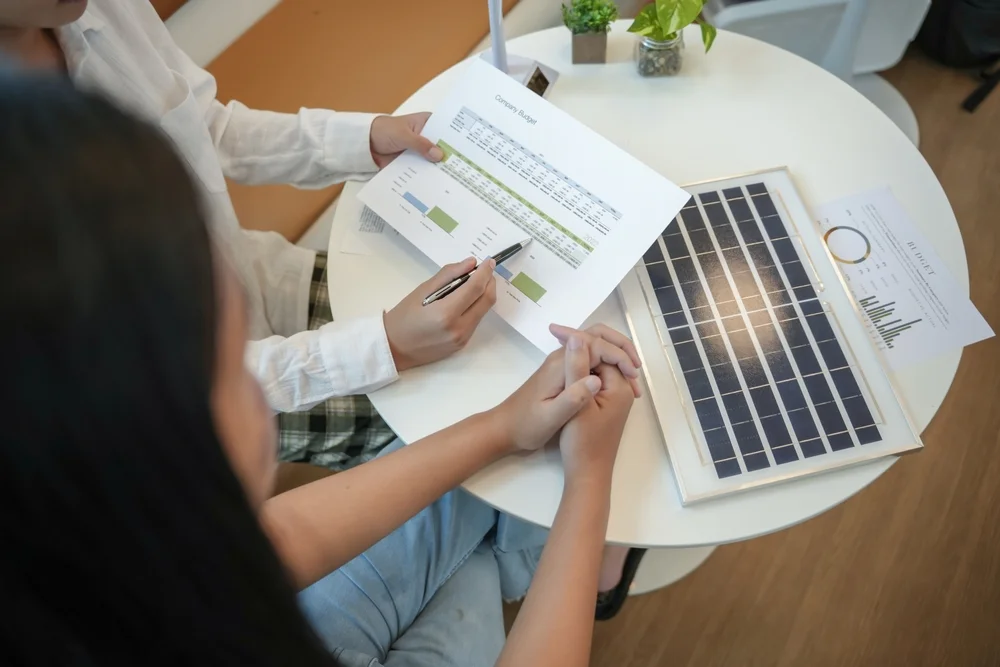 Solar panels green energy Business people working in green eco friendly office business meeting