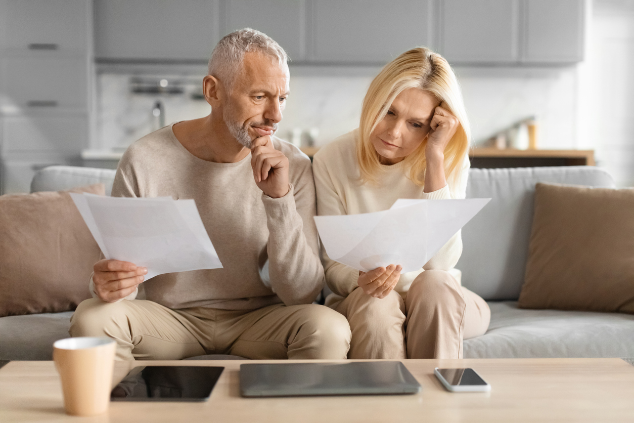Homeowner reviewing a solar installation contract, proposal, and manufacturer information before verifying the installed solar panels.