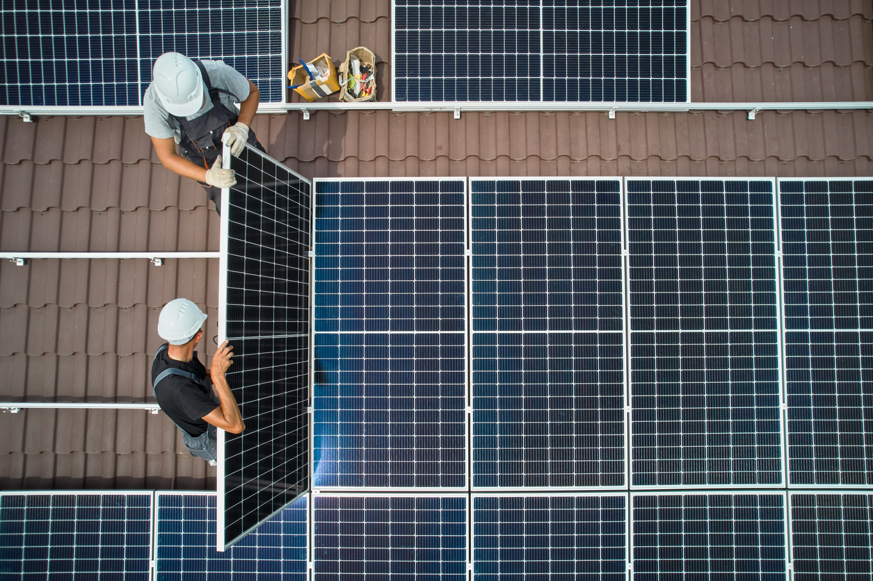 Solar panels getting inspected on a residential roof