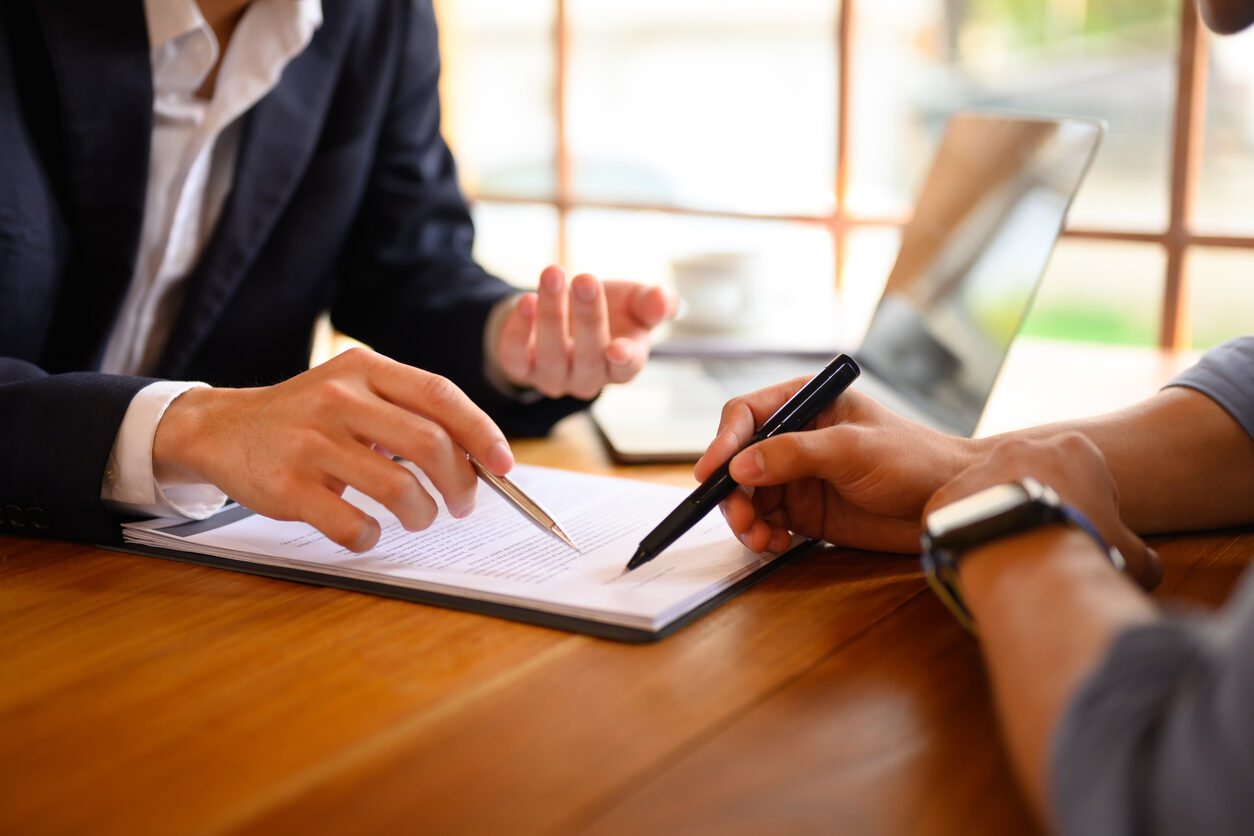 Person being rushed to sign a contract on the spot, illustrating high-pressure tactics used to prevent review of an arbitration clause before signing.