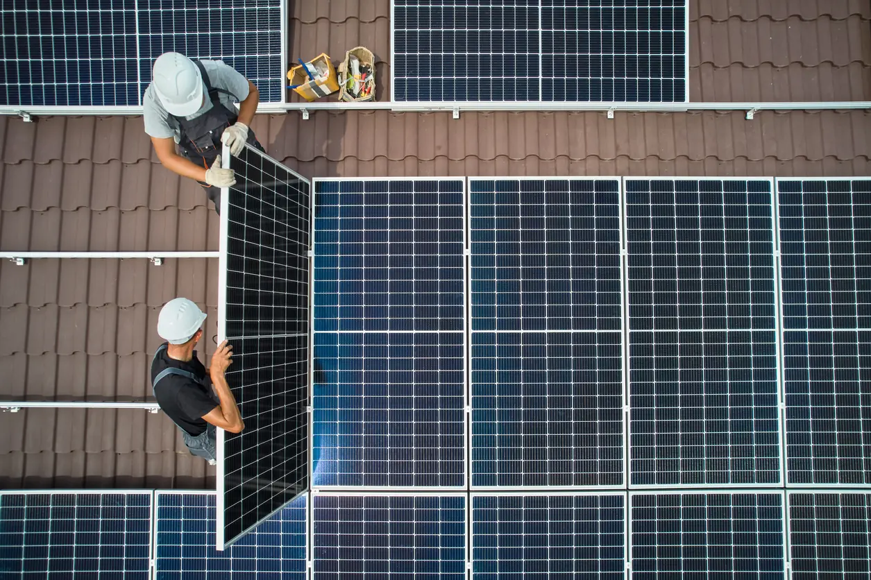 Solar panels getting inspected on a residential roof